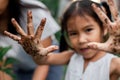 Child girl showing dirty hands after planting the tree in the garden Royalty Free Stock Photo