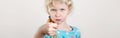 Child girl showing fig sign. Kid expressing strong negative emotion. Cute adorable blonde Caucasian preschool girl posing in