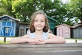 Child girl sit on bench wood table outdoor in summer day in wood hut village in Biganos Arcachon in France