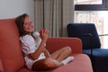 Child girl sitting on sofa with an apple, lifestyle stagging, healthy eating Royalty Free Stock Photo