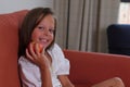 Child girl sitting on sofa with an apple, lifestyle stagging, healthy eating Royalty Free Stock Photo