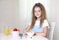 Child girl sitting at table and have a meal.Healthy nutrition concept.Morning breakfast.Young girl eating Royalty Free Stock Photo