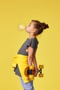 child girl with skateboard blowing a big bubble gum Royalty Free Stock Photo