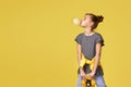 child girl with skateboard blowing a big bubble gum Royalty Free Stock Photo