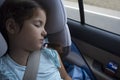 Child girl sleeping in a child safety seat during trip