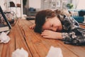 Child girl sleeping while doing homework. School kid learning hard and get tired