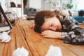 child girl sleeping while doing homework. School kid learning hard and get tired, papers with mistakes around. Education probl