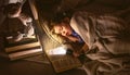 Child girl sleeping in tent with book and flashlight Royalty Free Stock Photo