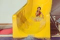 Child sliding down water slide in pool Royalty Free Stock Photo