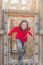 Girl on the sports wooden Playground