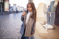 Child girl is standing next to shopwindow on city street in even Royalty Free Stock Photo