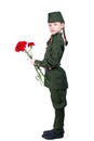 Child girl standing in a uniform with red flowers sideways, on a white background, and looking at you