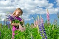 Child girl in summer flower field