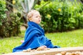 Child girl in towel after swimming basking in sun on tropical resort Royalty Free Stock Photo