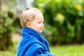 Child girl in towel after swimming basking in sun on tropical resort Royalty Free Stock Photo