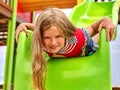 Child girl upside down on playground . Royalty Free Stock Photo