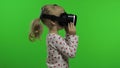 Child girl using VR headset helmet to play game. Watching virtual reality 3d 360 video. Chroma key Royalty Free Stock Photo