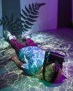 Girl with VR glasses laying on a floor, fluorescent light effects