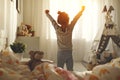 Child girl wakes up and stretches in morning in bed and stretch Royalty Free Stock Photo