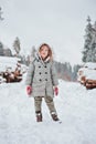 Child girl on the walk in winter snowy forest Royalty Free Stock Photo