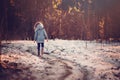 Child girl walking the road in winter snowy forest Royalty Free Stock Photo