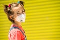 Child girl wearing a protection mask against coronavirus during Covid-19 pandemic Royalty Free Stock Photo