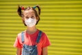 Child girl wearing a protection mask against coronavirus during Covid-19 pandemic Royalty Free Stock Photo