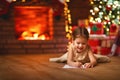 Child girl writing letter santa home near Christmas tree Royalty Free Stock Photo