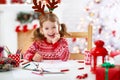 Child girl writing letter santa home near Christmas tree Royalty Free Stock Photo