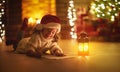 Child girl writing letter santa home near Christmas tree