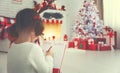 Child girl writing letter santa home near Christmas tree Royalty Free Stock Photo