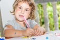 Child girl writing in notebook, outdoors portrait, educati Royalty Free Stock Photo