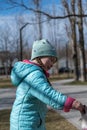 A child gives a pet a treat in a public park. A girl and a Chihuahua dog. Five-year-old child holding a pet treat in her hand. The Royalty Free Stock Photo