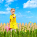 Child giving flower sky blue summer garden Royalty Free Stock Photo