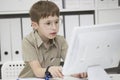 A child with glasses at the computer. Royalty Free Stock Photo