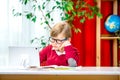 Child in glasses has online remote learning on tablet computer. Stress and frustration for school kids. Video conference Royalty Free Stock Photo