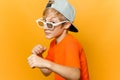 Child in glasses for watching movies clenched his fists and looks askance at the camera Royalty Free Stock Photo