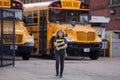 Child go to school. Schoolboy with backpack and book getting on school bus. American School. Happy children ready to Royalty Free Stock Photo