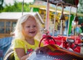 child goes for a drive on a children's attraction