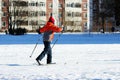 child goes skiing on the inner court of the school during physical education classes Royalty Free Stock Photo