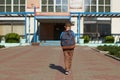 The child goes to school. boy schoolboy goes to school in the morning. happy child with a briefcase on his back and textbooks in Royalty Free Stock Photo