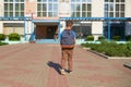 The child goes to school. boy schoolboy goes to school in the morning. happy child with a briefcase on his back and textbooks in Royalty Free Stock Photo