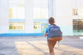 The child goes to school. boy schoolboy goes to school in the morning. happy child with a briefcase on his back and textbooks in Royalty Free Stock Photo