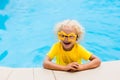 Child with goggles in swimming pool. Kids swim. Royalty Free Stock Photo