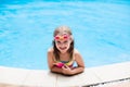 Child with goggles in swimming pool. Kids swim. Royalty Free Stock Photo