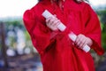 Close-up of Hands of Kindergartner in Red Graduation Gown