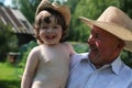Child and grandfather in cowboy hats Royalty Free Stock Photo