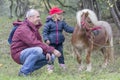 Child, grandfather and pony