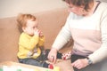 Child with grandmother playing Royalty Free Stock Photo