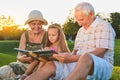 Child with grandparents, photo album. Royalty Free Stock Photo